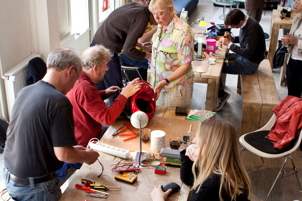 Repair cafe volunteers fixing items